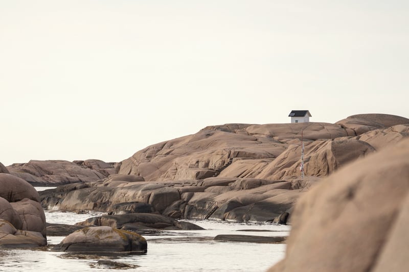 Granite coastline with a lone cabin