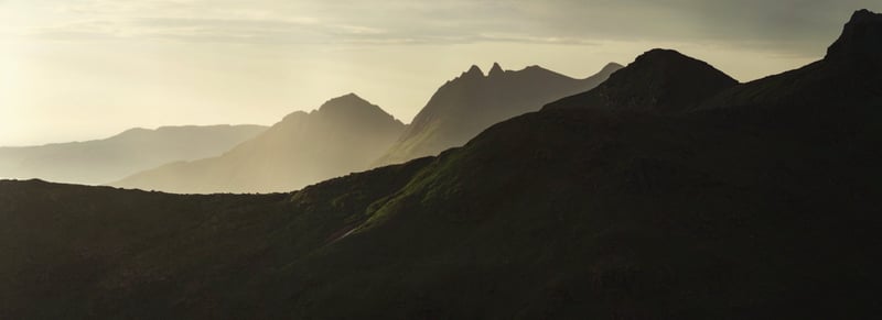 Norwegian mountains falling to the water at dusk