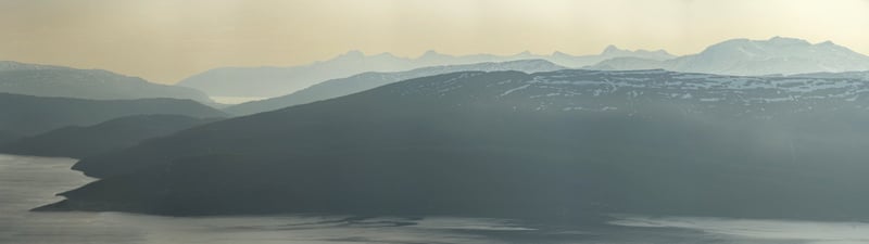 Layered blue Nordic mountains in mist