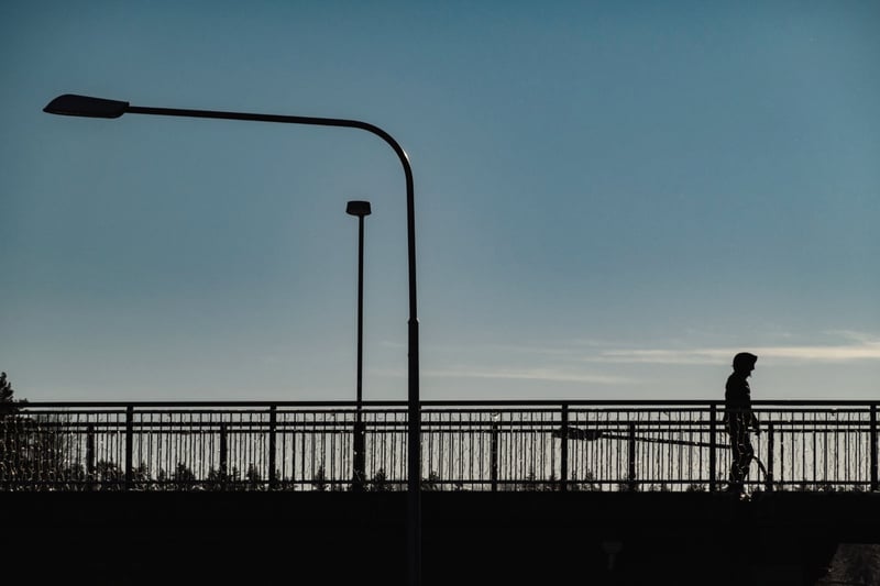 A figure on a Nordic pier under a streetlight